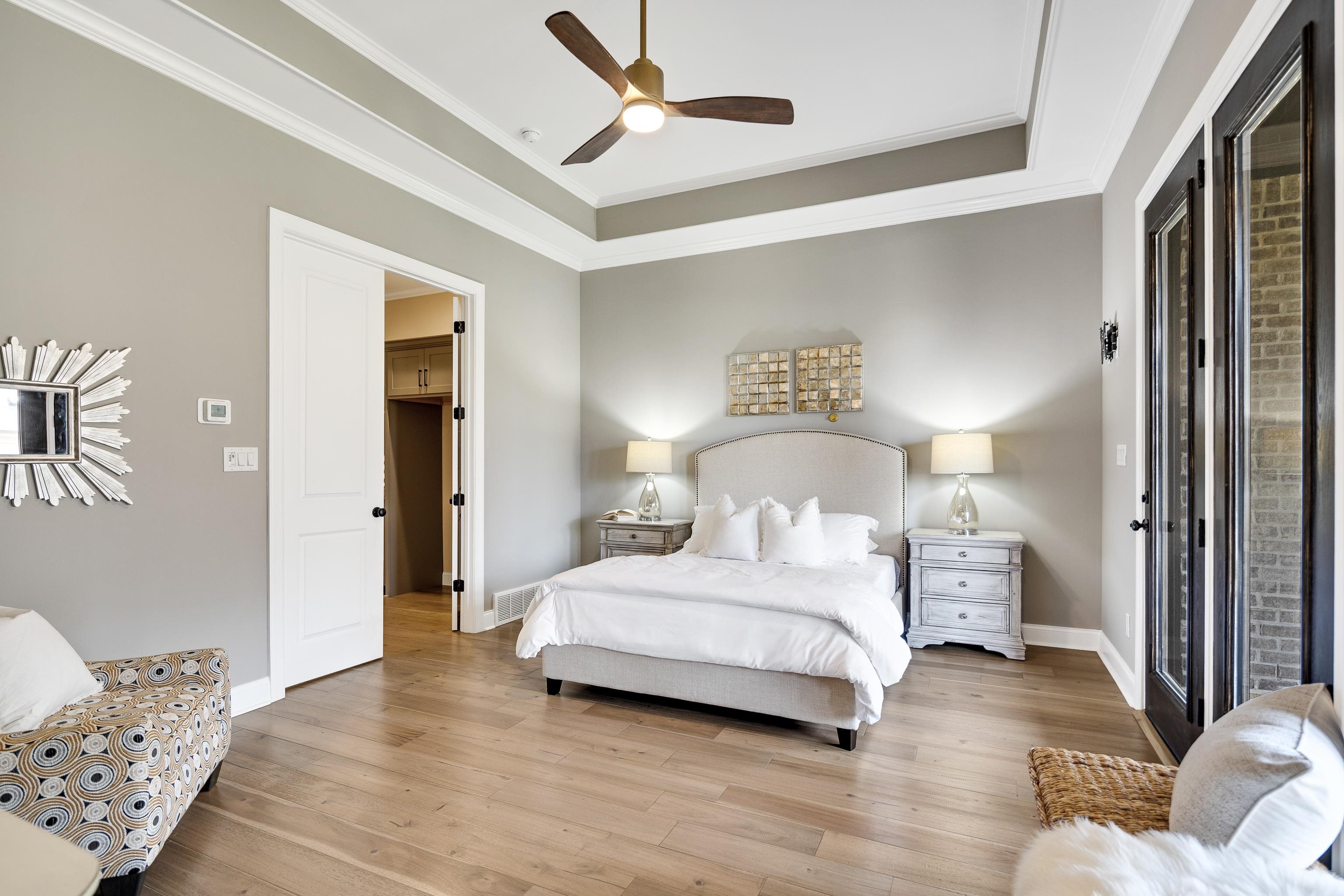 237 Beckham Drive Collierville, TN 38017 - Photo 29 of 40 Bedroom with wood finished floors, baseboards, crown molding, a ceiling fan, and a raised ceiling