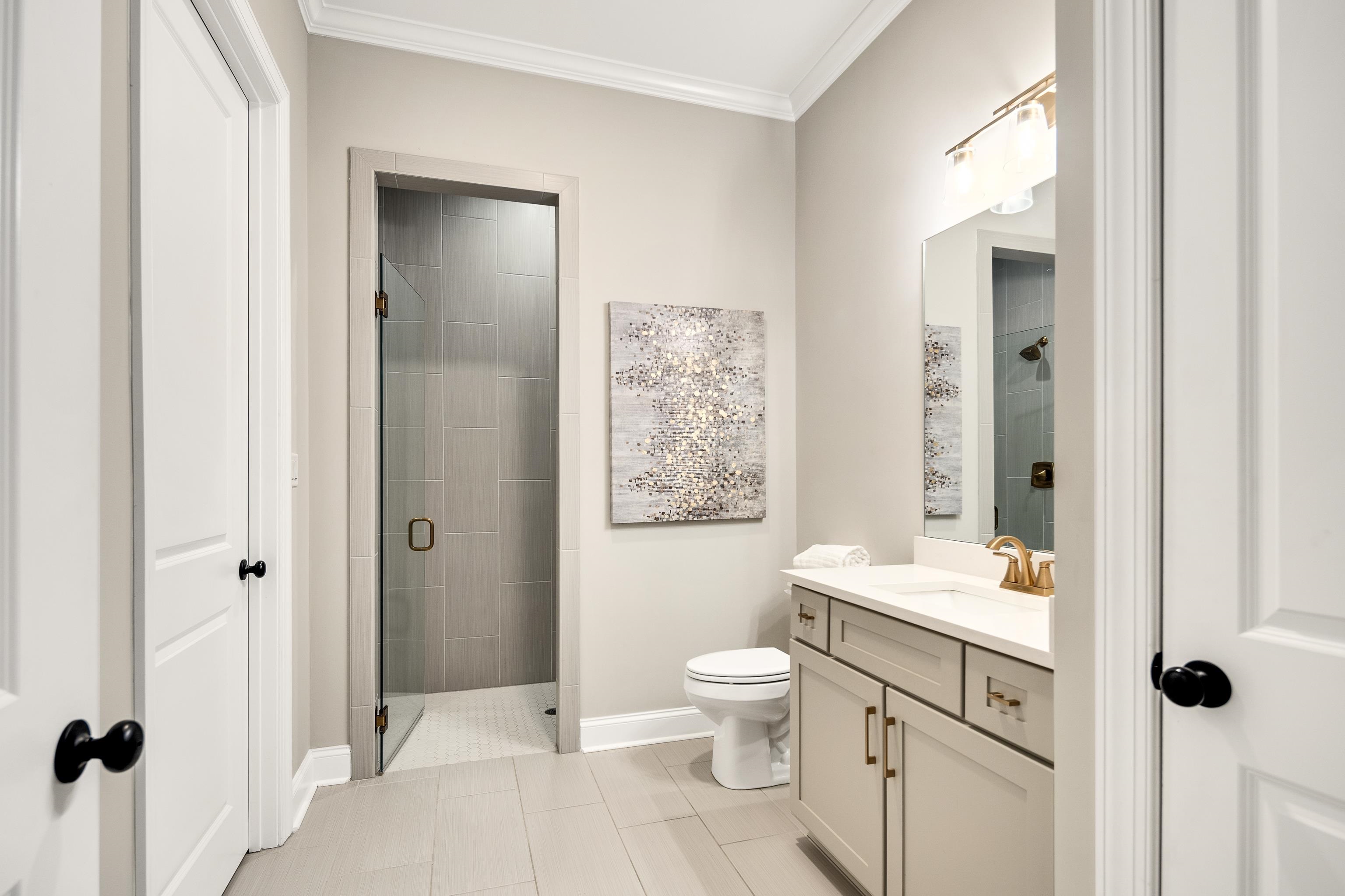 237 Beckham Drive Collierville, TN 38017 - Photo 31 of 40 Full bathroom with a shower stall, vanity, tile patterned floors, ornamental molding, and toilet