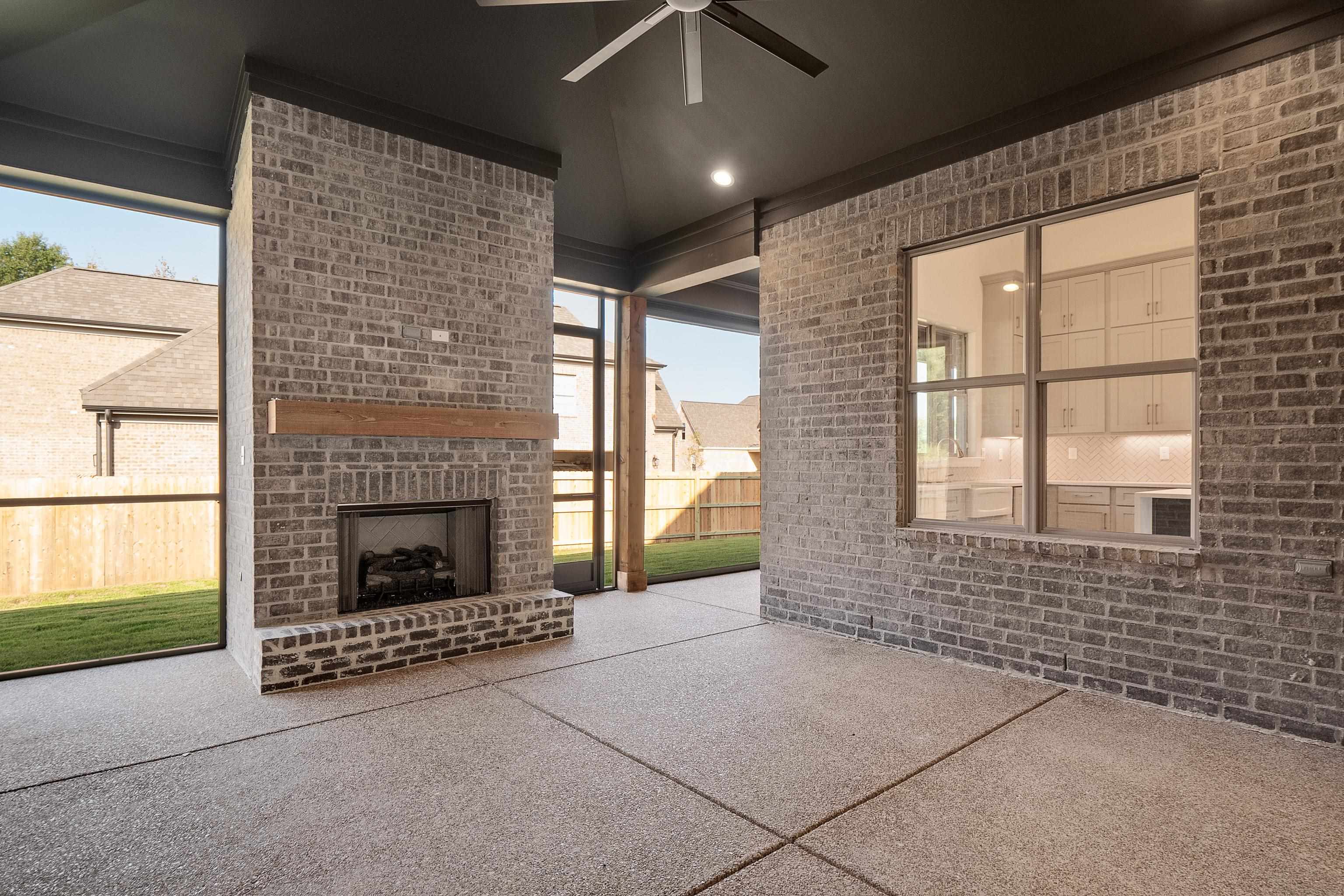 237 Beckham Drive Collierville, TN 38017 - Photo 32 of 40 View of patio / terrace featuring an outdoor brick fireplace, fence, and a ceiling fan