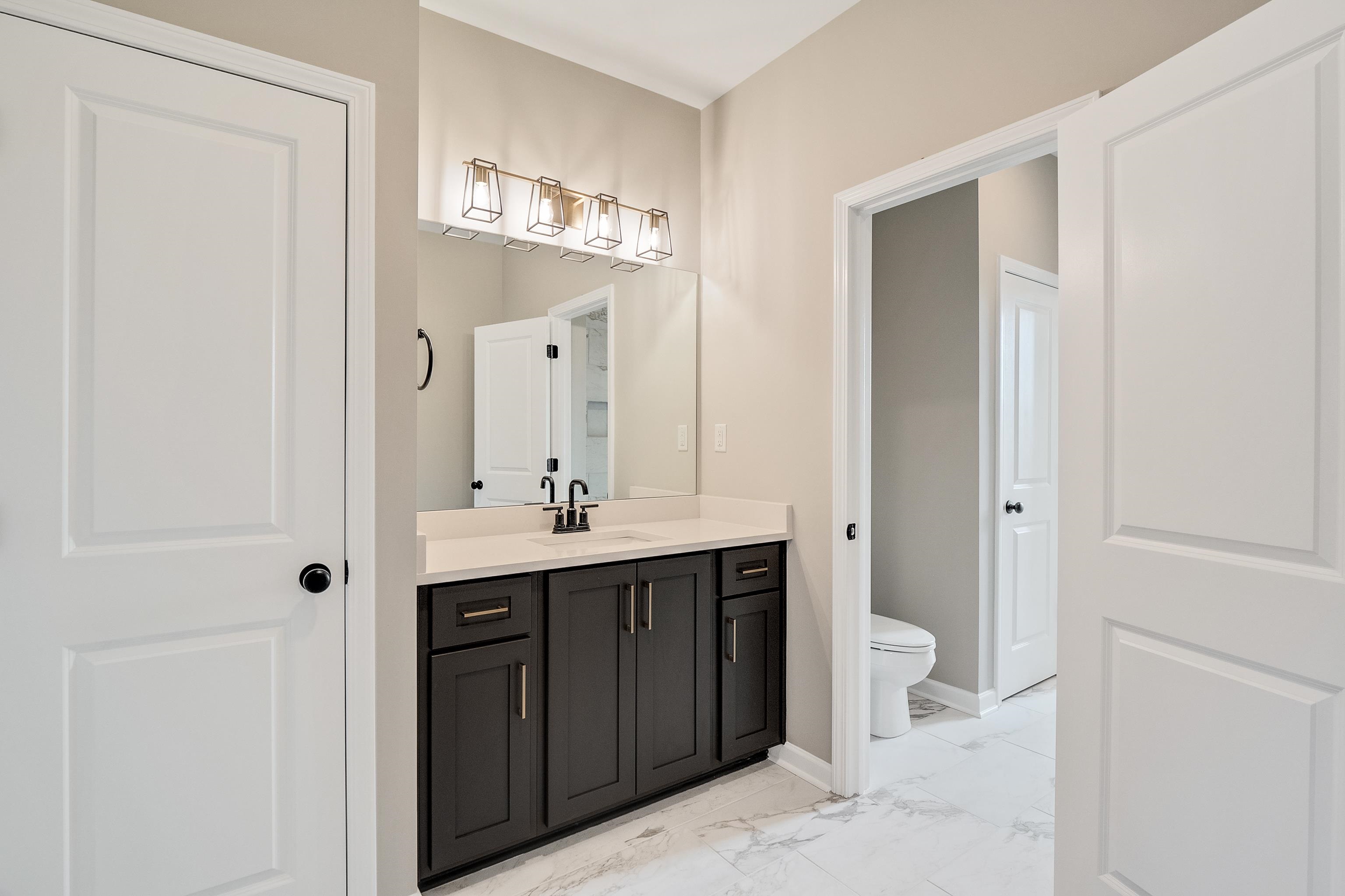 237 Beckham Drive Collierville, TN 38017 - Photo 38 of 40 Bathroom with toilet, marble finish floor, baseboards, and vanity