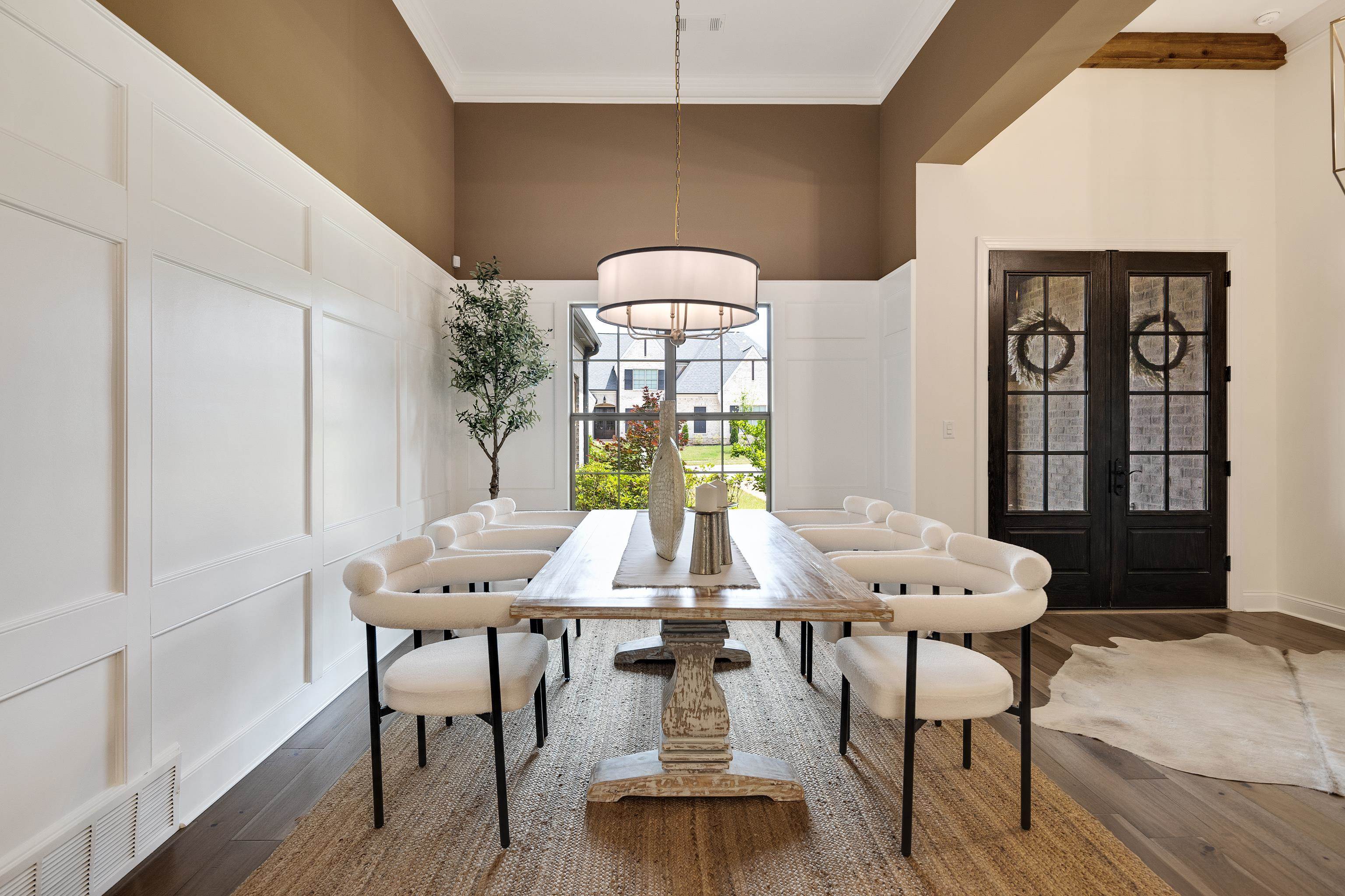 237 Beckham Drive Collierville, TN 38017 - Photo 5 of 40 Dining area featuring a decorative wall, dark wood-style flooring, ornamental molding, french doors, and a towering ceiling