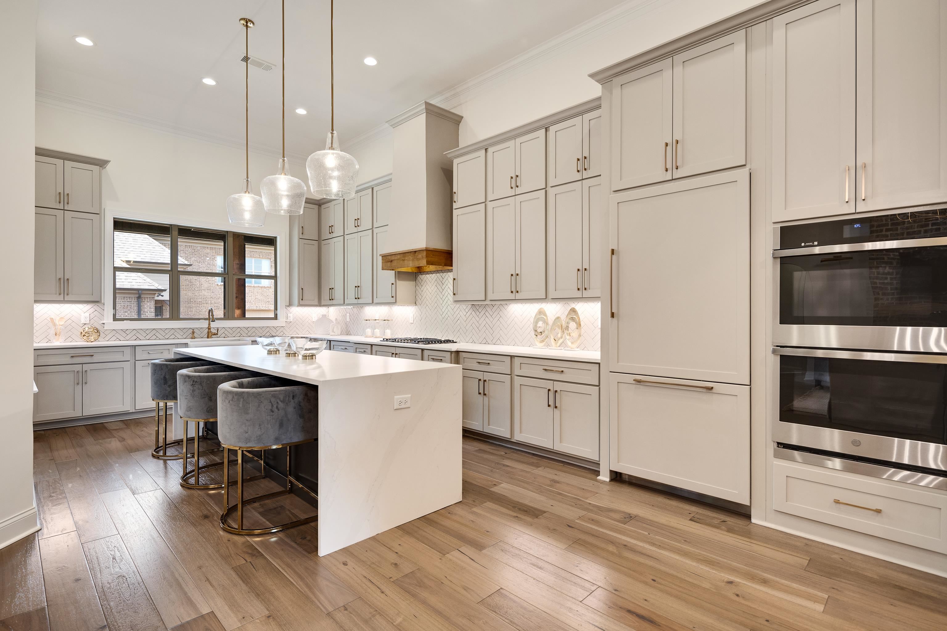 237 Beckham Drive Collierville, TN 38017 - Photo 8 of 40 Kitchen with appliances with stainless steel finishes, crown molding, gray cabinetry, backsplash, and recessed lighting