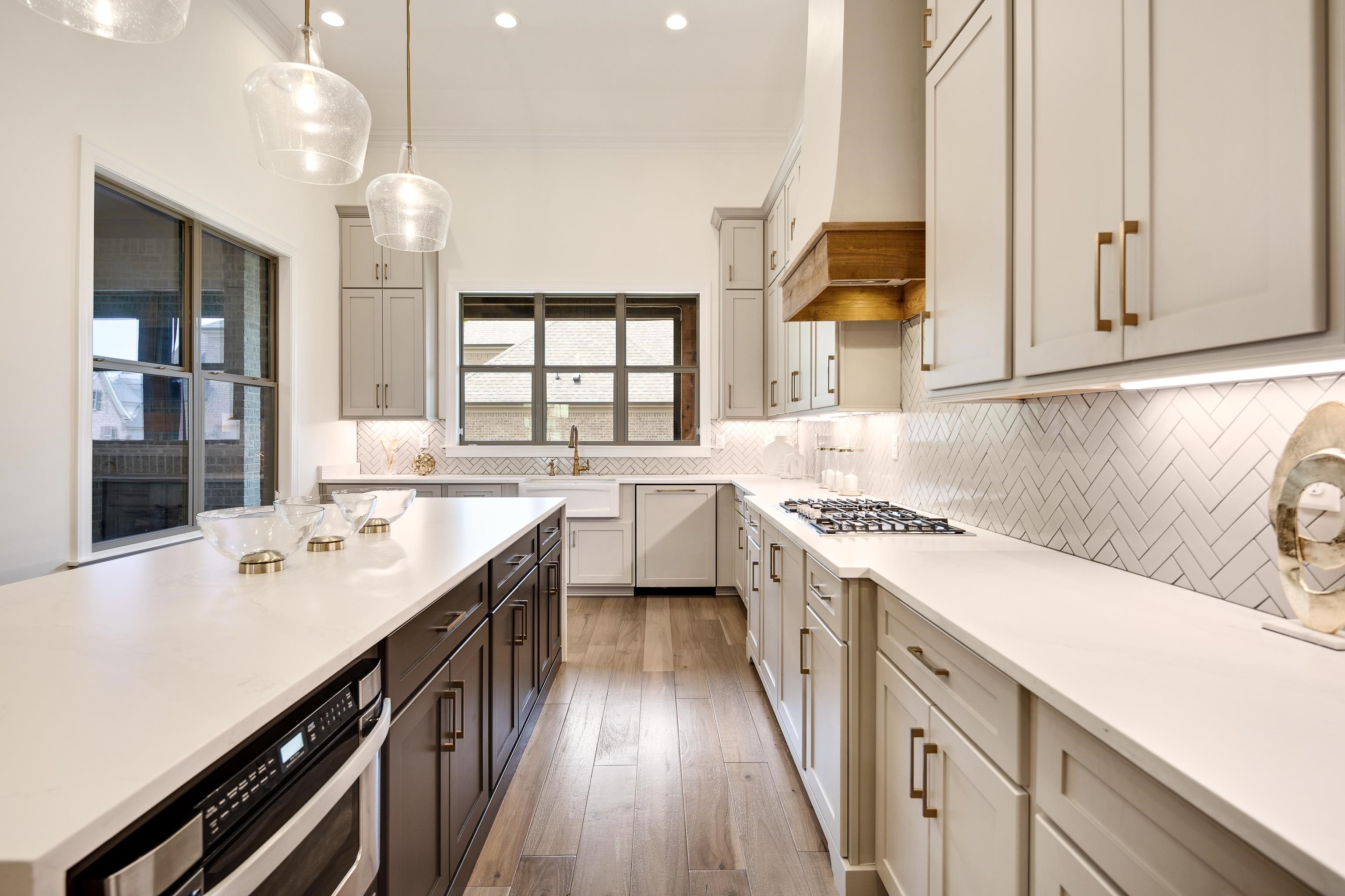 237 Beckham Drive Collierville, TN 38017 - Photo 10 of 40 Kitchen with white dishwasher, stainless steel gas stovetop, light countertops, custom exhaust hood, and recessed lighting