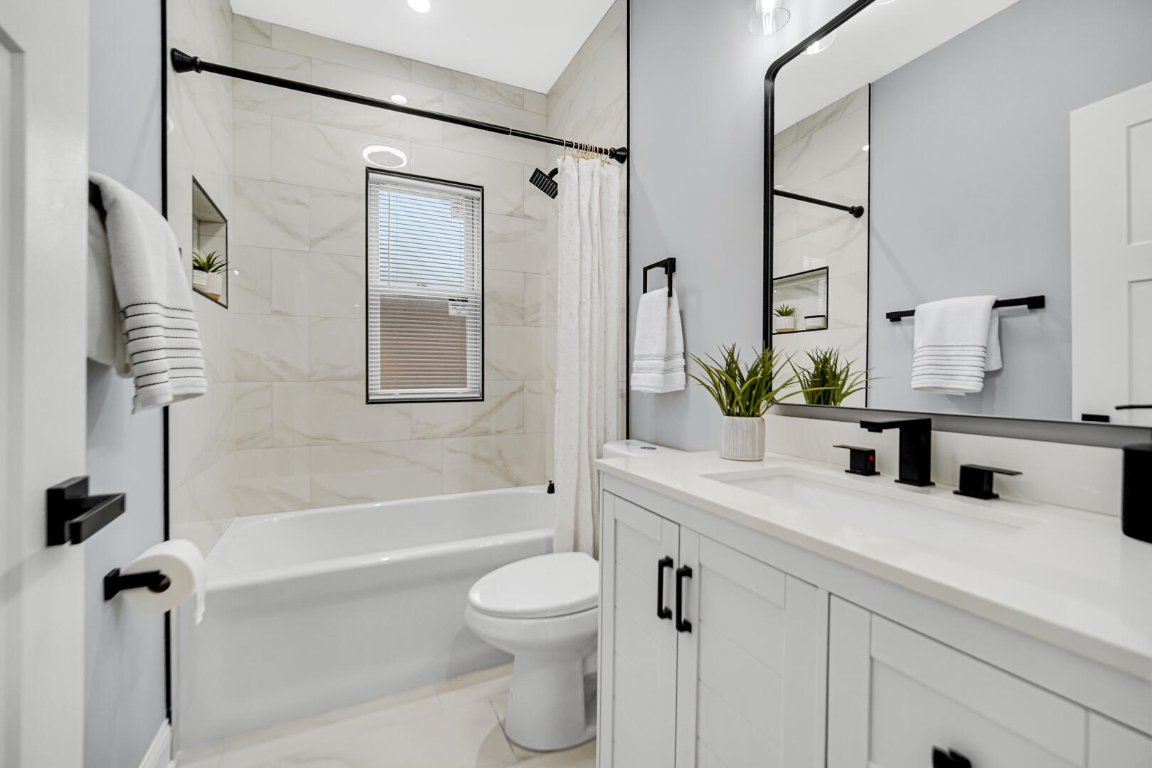 4354 Washington Street Gary, IN 46408 - Photo 13 of 32 a bathroom with a granite countertop sink a toilet a mirror a vanity and shower