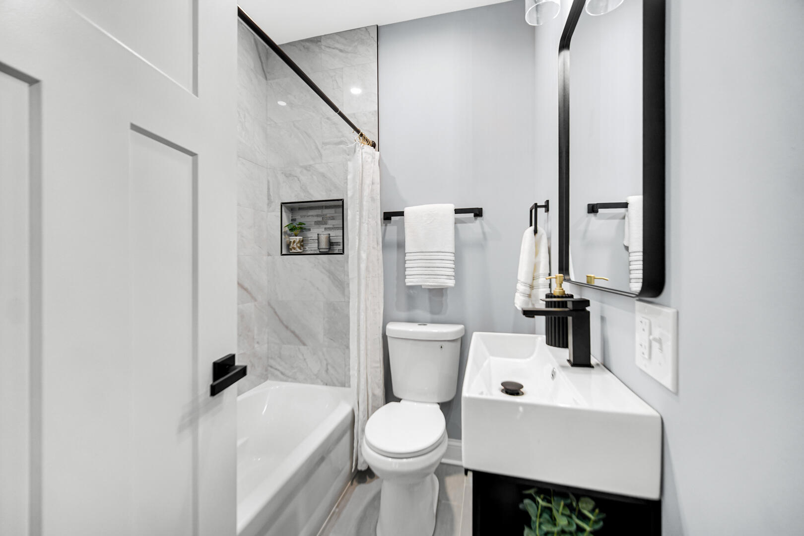 4354 Washington Street Gary, IN 46408 - Photo 17 of 32 a white toilet sitting next to a bathroom sink