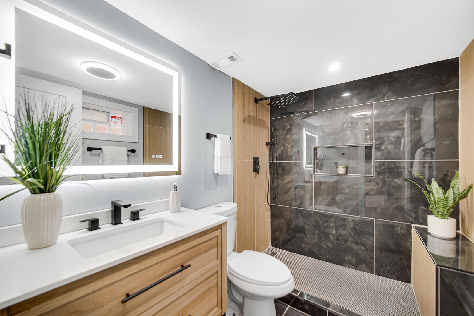 4354 Washington Street Gary, IN 46408 - Photo 26 of 32 a bathroom with a sink a toilet a glass door a shower and a mirror