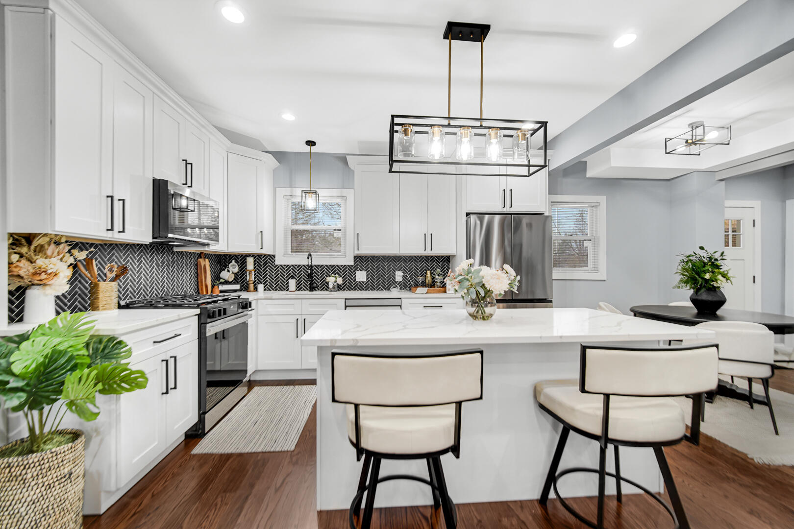 4354 Washington Street Gary, IN 46408 - Photo 9 of 32 a kitchen with stainless steel appliances kitchen island a refrigerator and a stove top oven