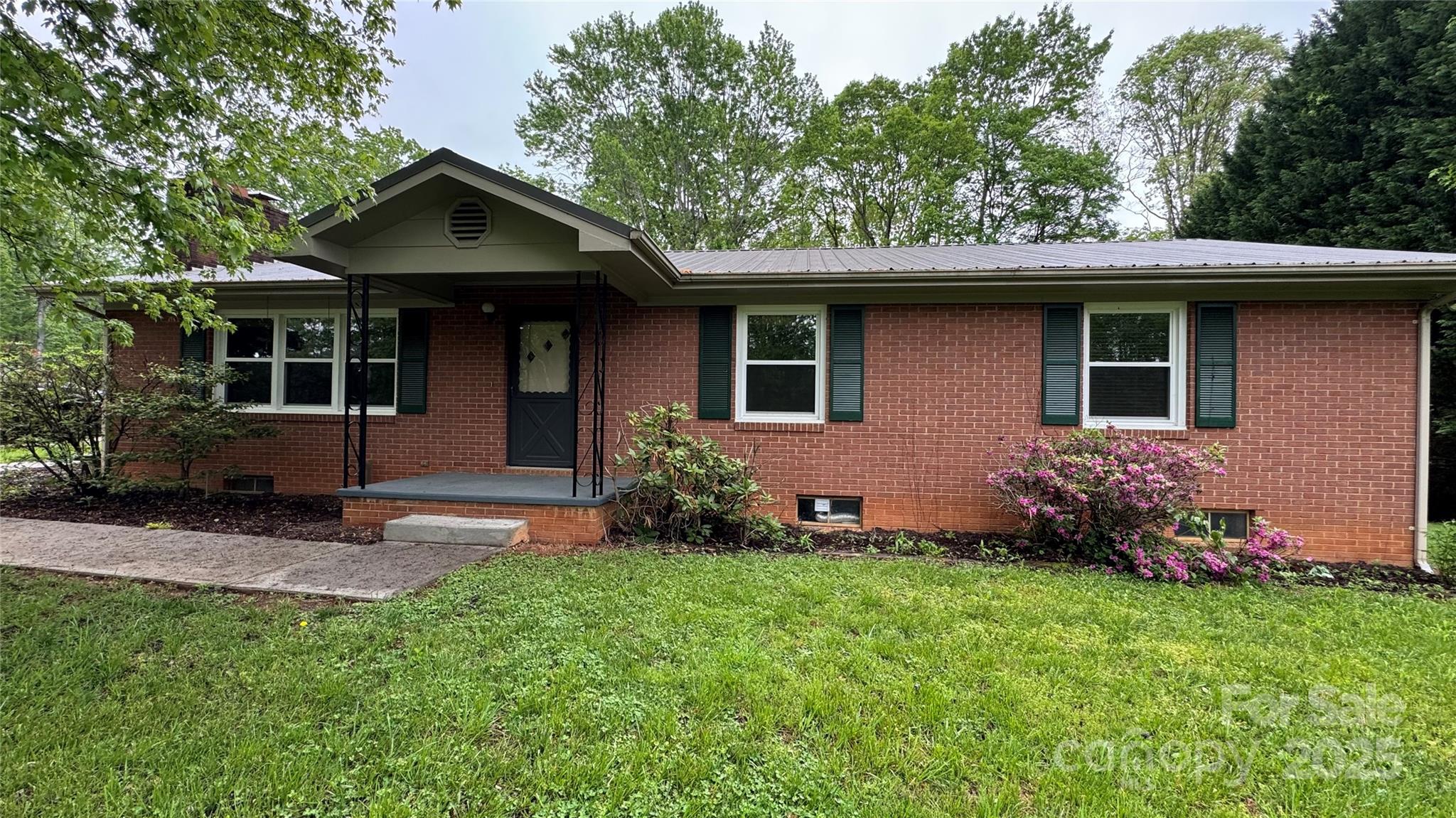 105 Cooper Drive Nebo, NC 28761 - Photo 1 of 17 a front view of a house with a garden