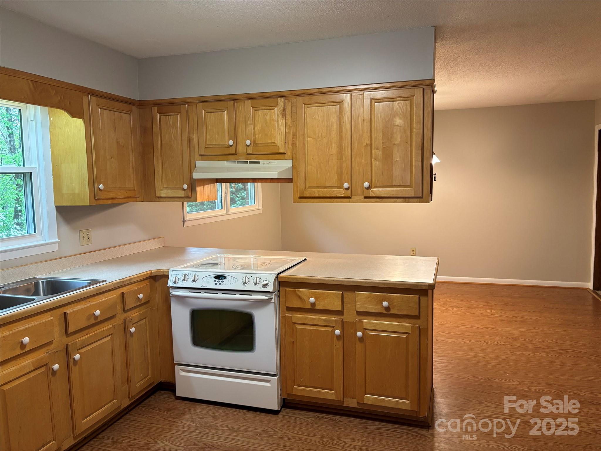 105 Cooper Drive Nebo, NC 28761 - Photo 5 of 17 a kitchen with cabinets appliances and a window