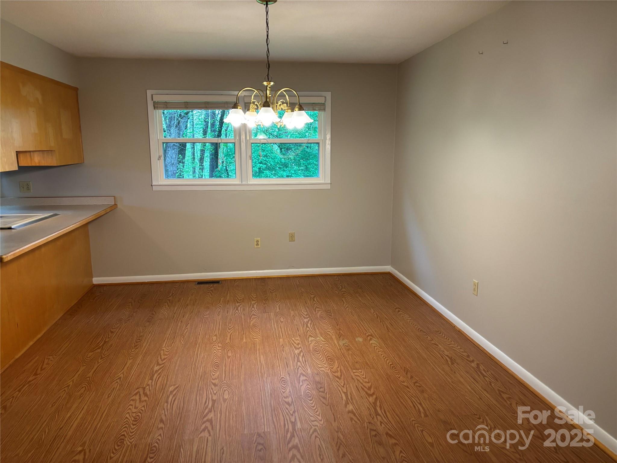 105 Cooper Drive Nebo, NC 28761 - Photo 6 of 17 a view of an empty room with a window and wooden floor