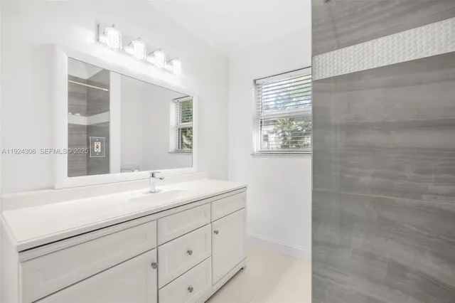 a bathroom with a sink double vanity and a shower