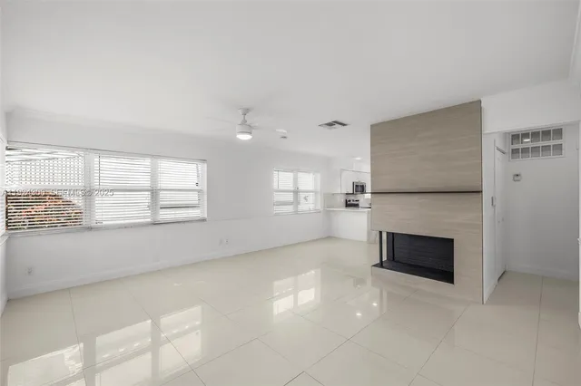 a view of empty room with a fireplace
