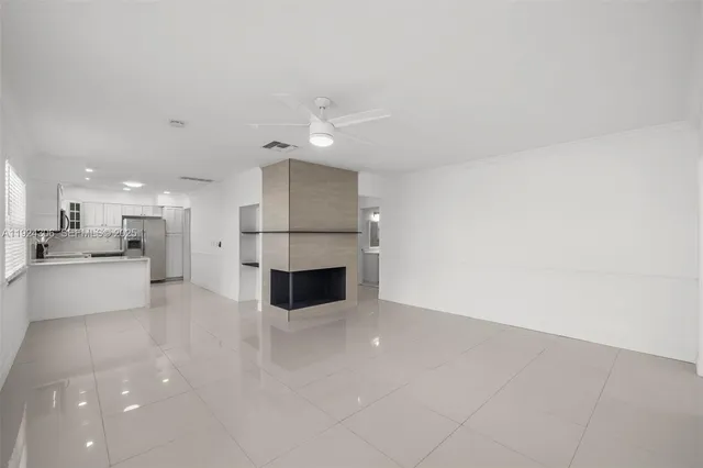 a open kitchen with white cabinets and stainless steel appliances