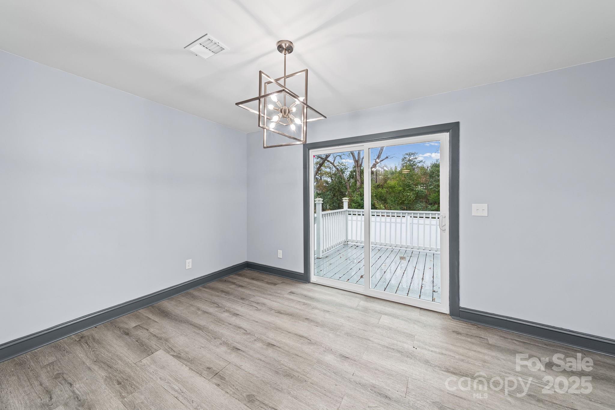 109 Haddock Road Northwest Orangeburg, SC 29115 - Photo 14 of 48 a view of a room with wooden floor a ceiling fan and windows