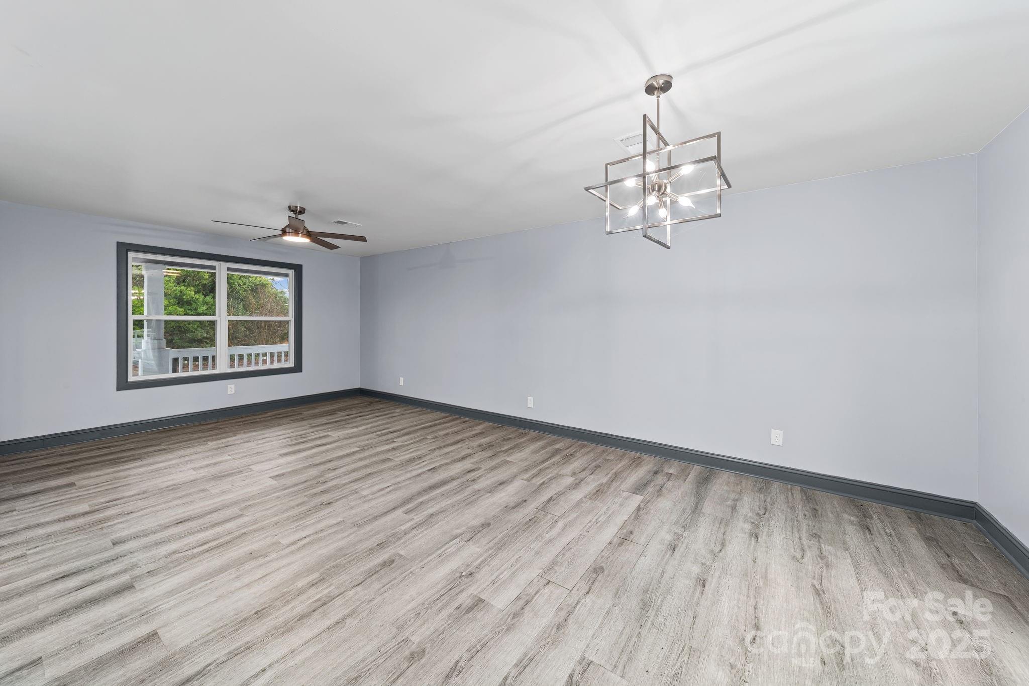 109 Haddock Road Northwest Orangeburg, SC 29115 - Photo 16 of 48 an empty room with wooden floor and windows