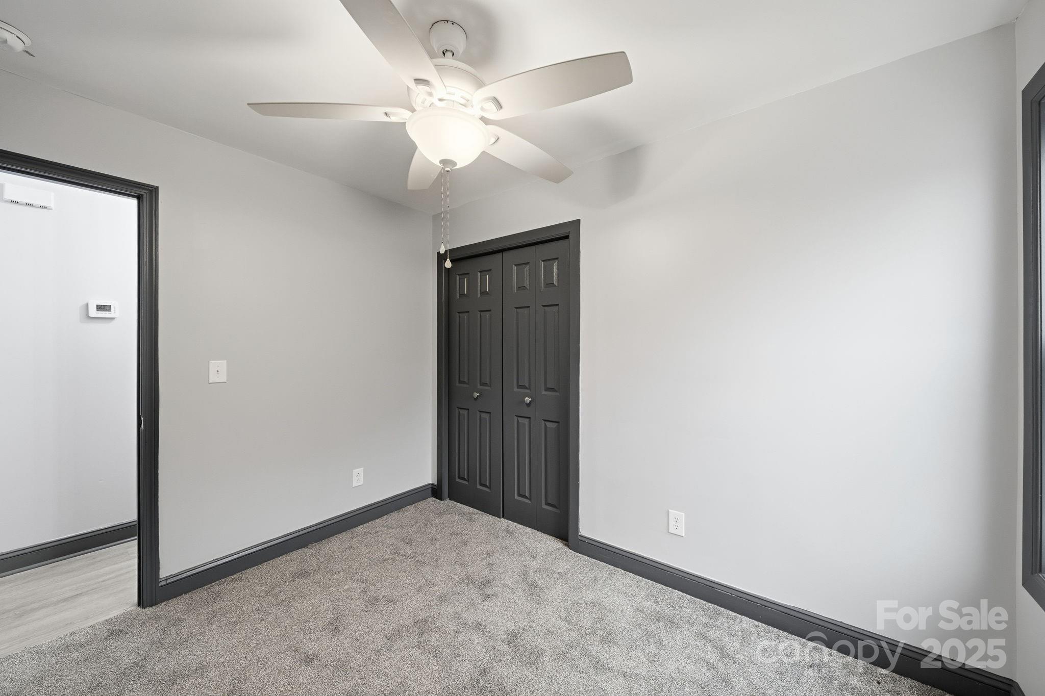 109 Haddock Road Northwest Orangeburg, SC 29115 - Photo 31 of 48 an empty room with a chandelier fan and closet