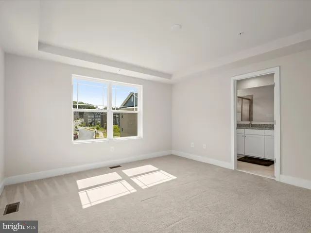 a view of an empty room and a window