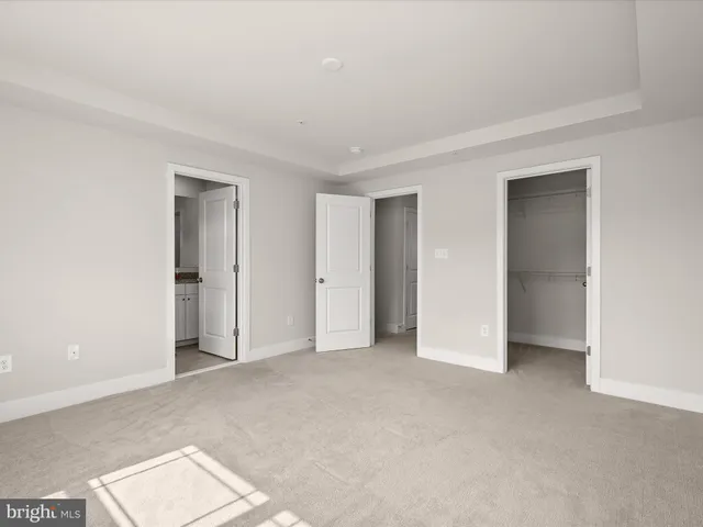 a view of an empty room and closet area