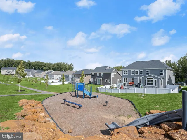 a view of a big house with a big yard and potted plants