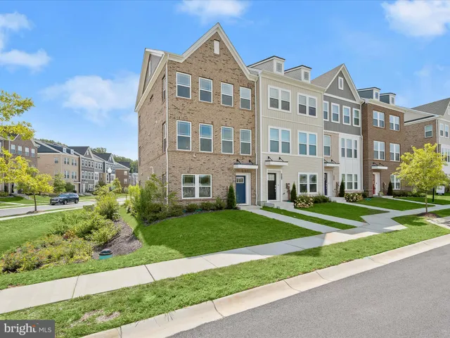 a front view of a residential apartment building with a yard