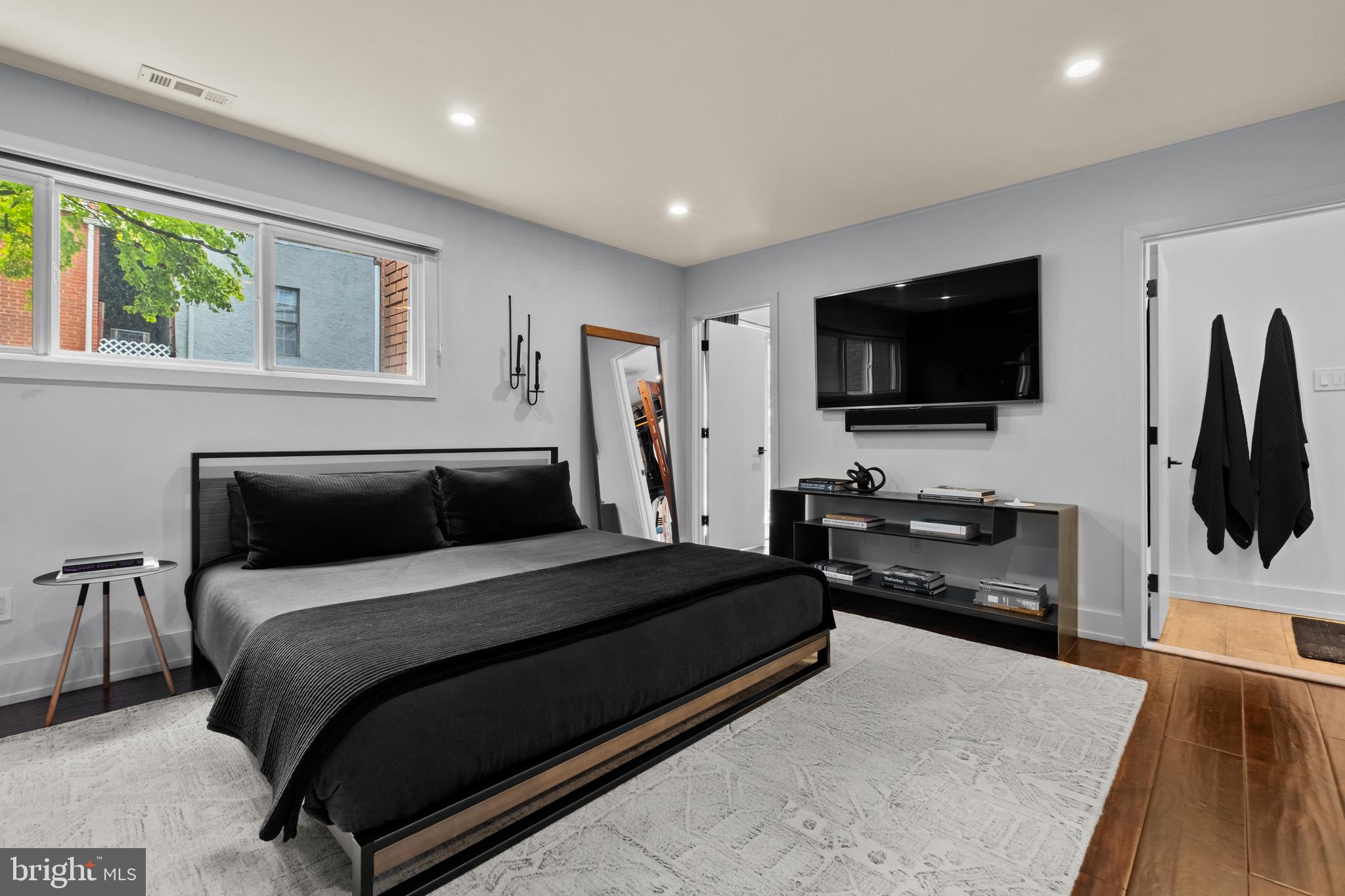 502 Delancey Street, Unit A Philadelphia, PA 19106 - Photo 18 of 32 a bedroom with a bed and a flat screen tv