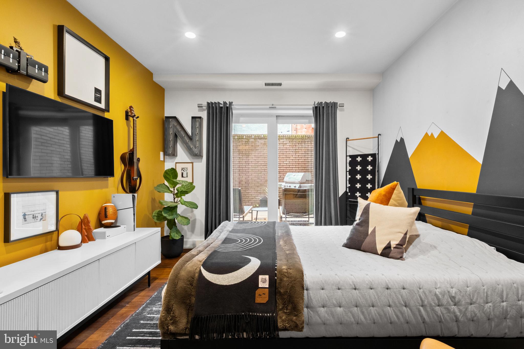 502 Delancey Street, Unit A Philadelphia, PA 19106 - Photo 26 of 32 a bedroom with a bed and wooden floor