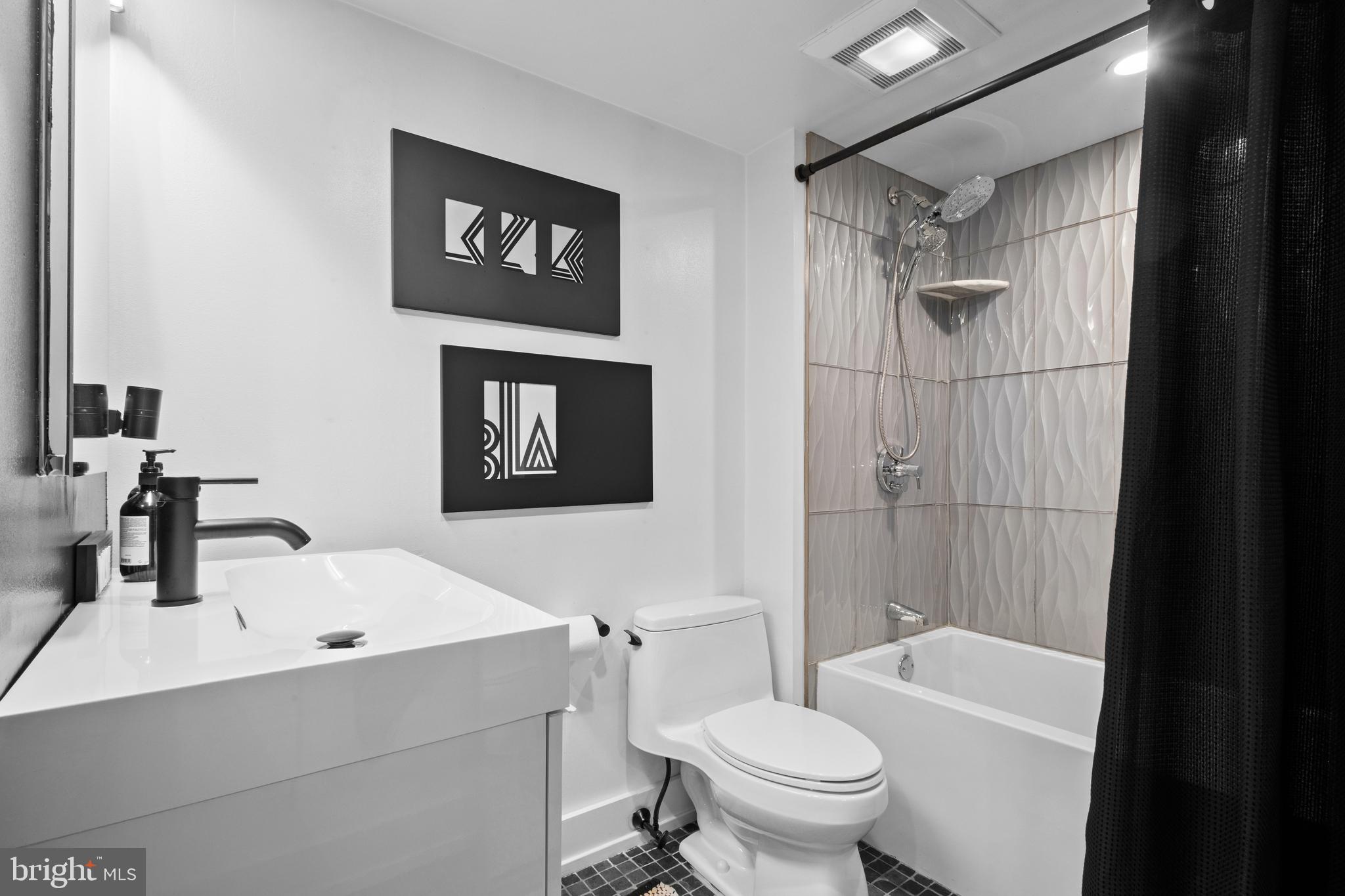 502 Delancey Street, Unit A Philadelphia, PA 19106 - Photo 27 of 32 a bathroom with a sink a toilet and shower