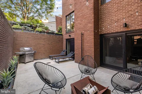 a view of a patio with a table and chairs