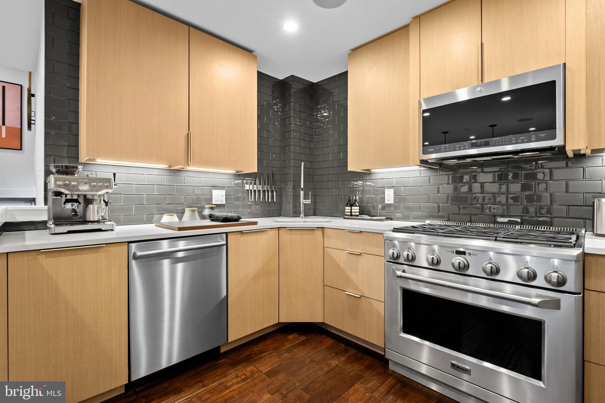 502 Delancey Street, Unit A Philadelphia, PA 19106 - Photo 7 of 32 a kitchen with stainless steel appliances a stove microwave and sink