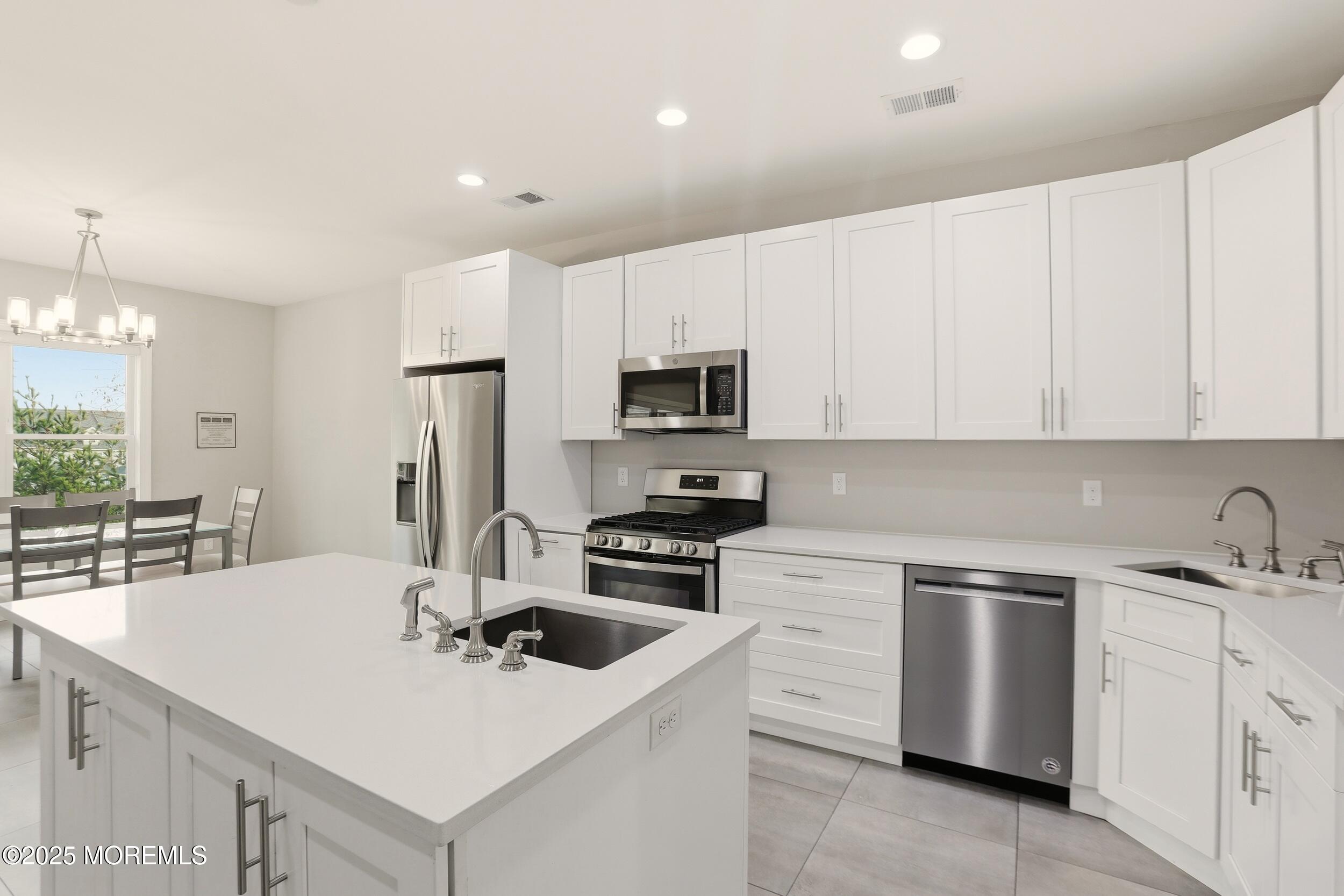 119 North Zinfandel Road Lakewood, NJ 08701 - Photo 14 of 29 a kitchen with white cabinets stainless steel appliances and sink