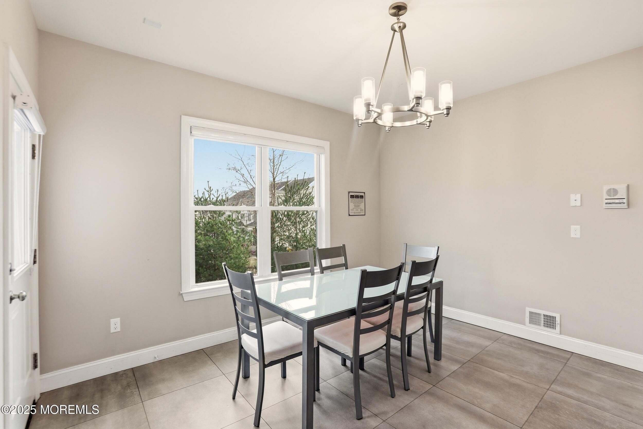 119 North Zinfandel Road Lakewood, NJ 08701 - Photo 16 of 29 a view of a dining room with furniture a chandelier and wooden floor