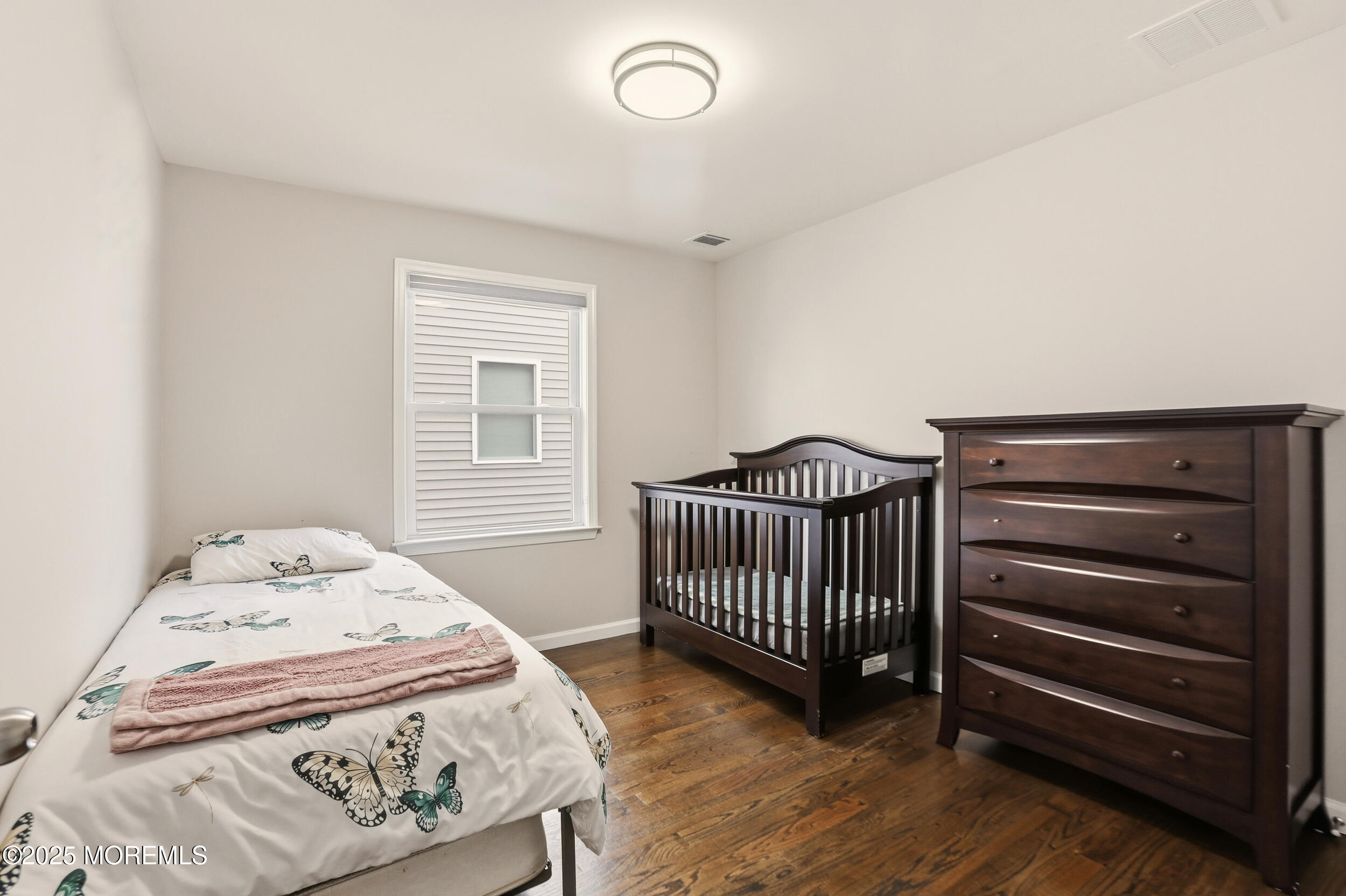 119 North Zinfandel Road Lakewood, NJ 08701 - Photo 21 of 29 a bedroom with a bed and wooden floor