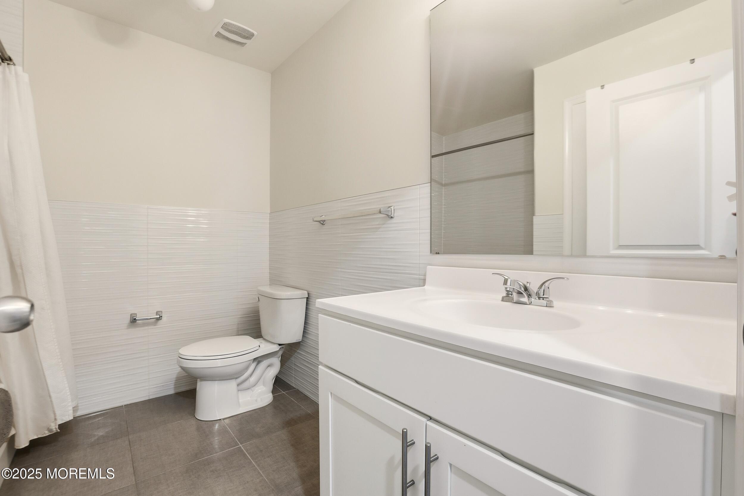 119 North Zinfandel Road Lakewood, NJ 08701 - Photo 22 of 29 a bathroom with a sink toilet and vanity
