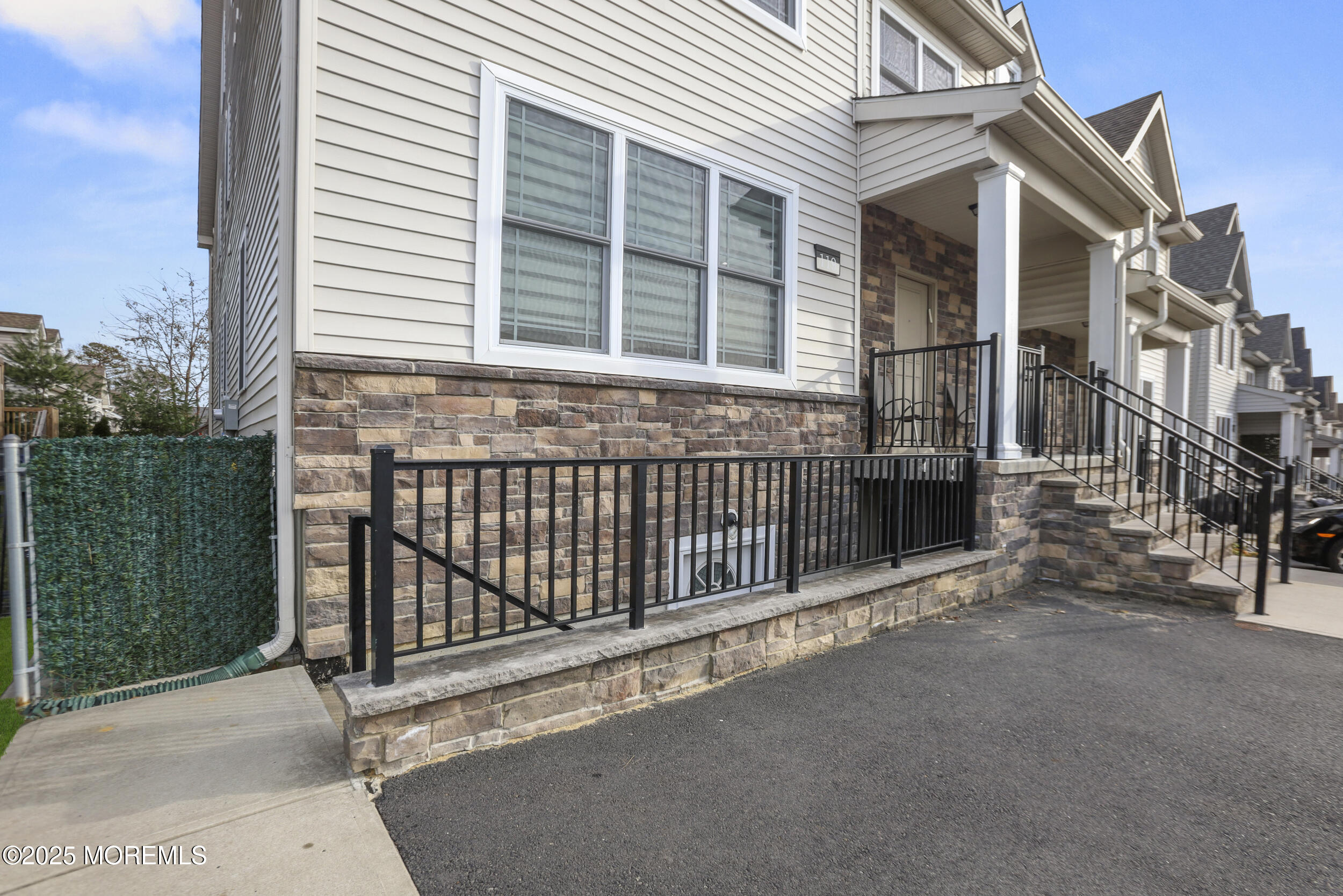 119 North Zinfandel Road Lakewood, NJ 08701 - Photo 4 of 29 a view of a house with a small yard and wooden fence