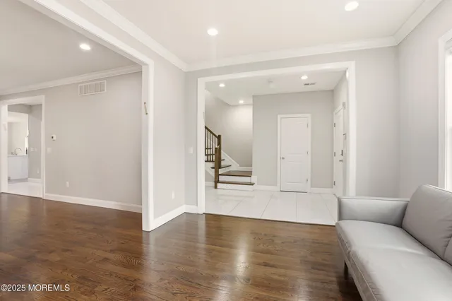 a view of a livingroom with wooden floor and cabinet