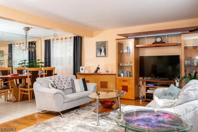 a view of a dining room with furniture and chandelier