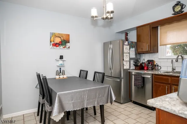 a kitchen with a stove a sink and a refrigerator