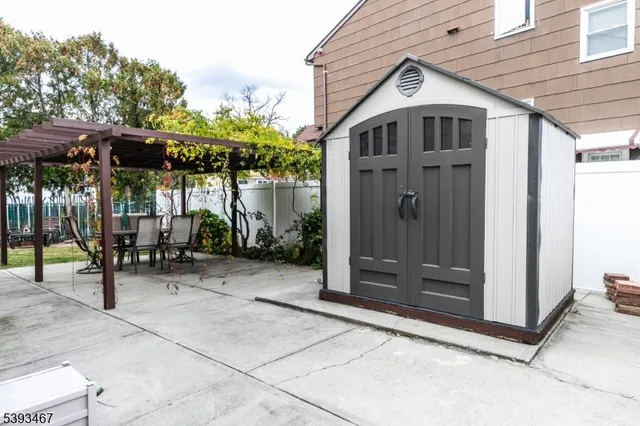 a view of a house with backyard and sitting area
