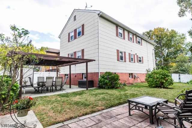 a view of a house with backyard and sitting area