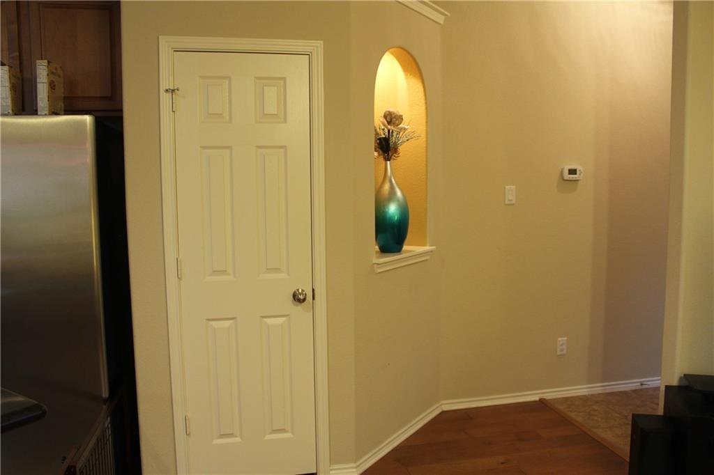 1310 West Parmer Lane, Unit 1503 Austin, TX 78727 - Photo 13 of 26 Hallway featuring dark wood-style flooring and arched walkways