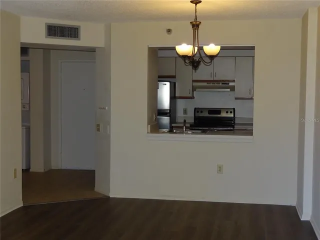 a view of dining room with wooden floor and a ceiling fan