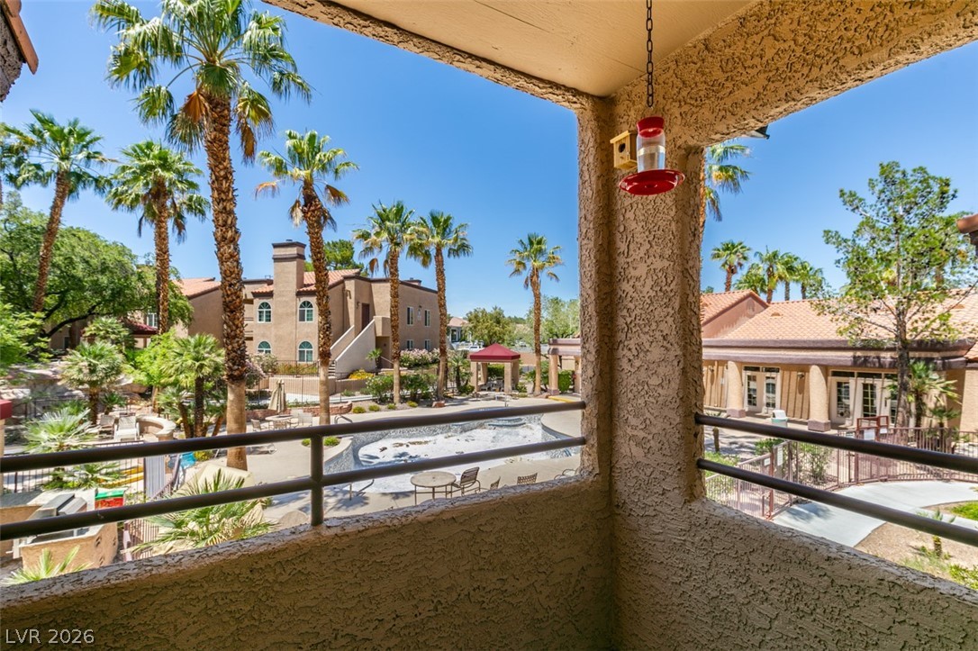 9325 West Desert Inn Road, Unit 244 Las Vegas, NV 89117 - Photo 35 of 55 A private balcony overlooks the community pool and lush, palm-dotted courtyards.