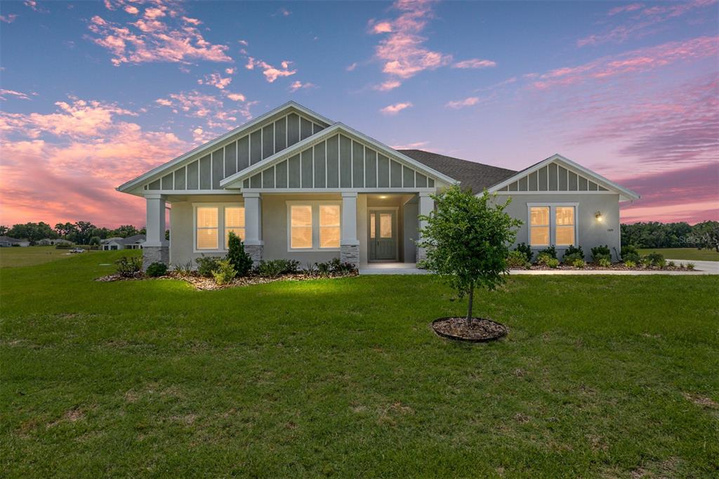 a front view of a house with a garden