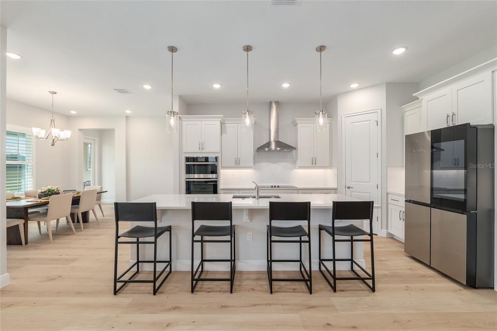 1929 Northwest 85th Loop Ocala, FL 34475 - Photo 14 of 55 a large kitchen with a table and chairs