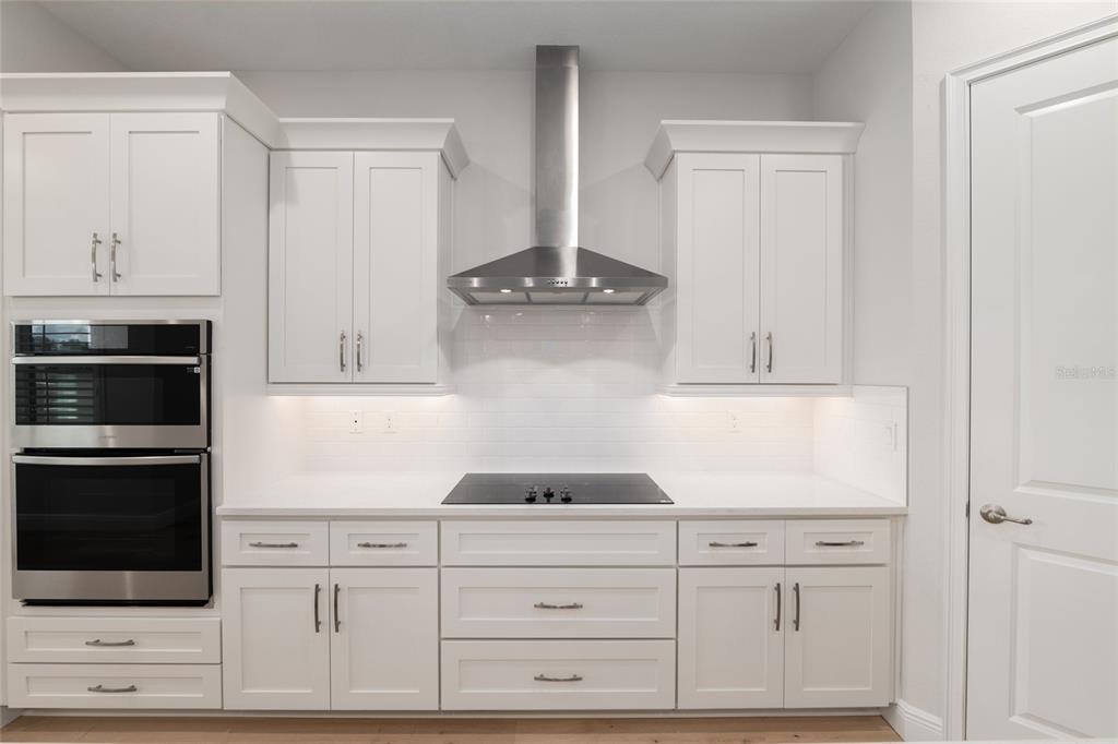 1929 Northwest 85th Loop Ocala, FL 34475 - Photo 17 of 55 a kitchen with white cabinets and stainless steel appliances