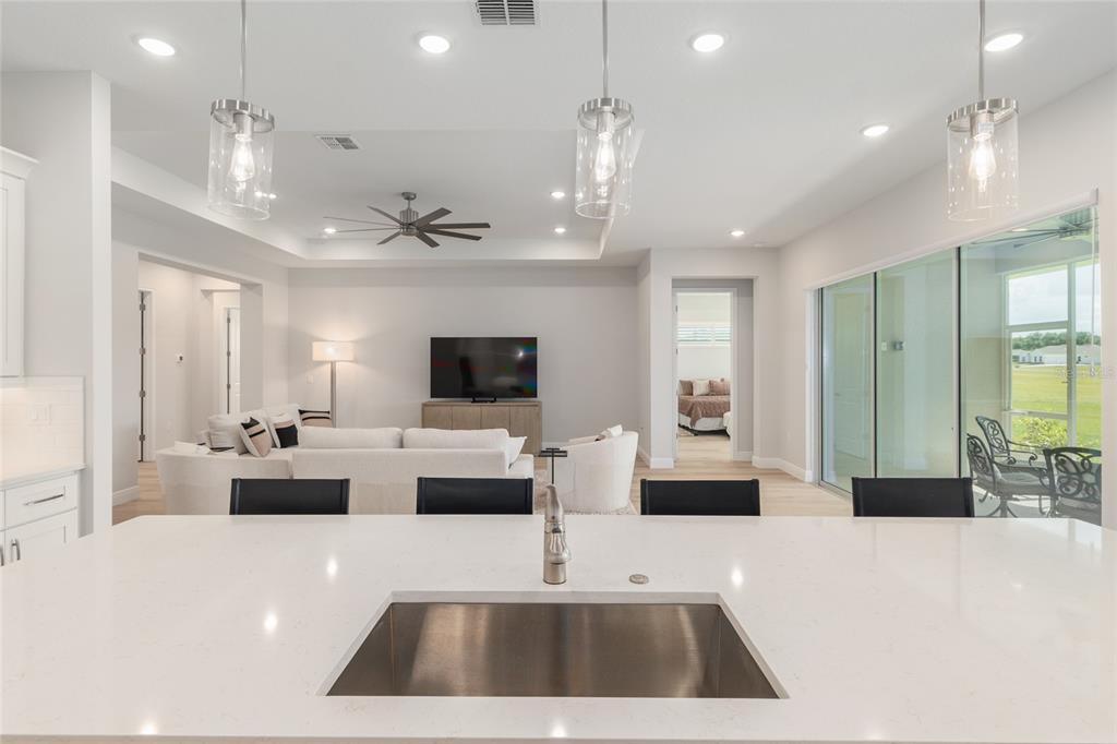 1929 Northwest 85th Loop Ocala, FL 34475 - Photo 19 of 55 a large living room with stainless steel appliances a couch and a flat screen tv