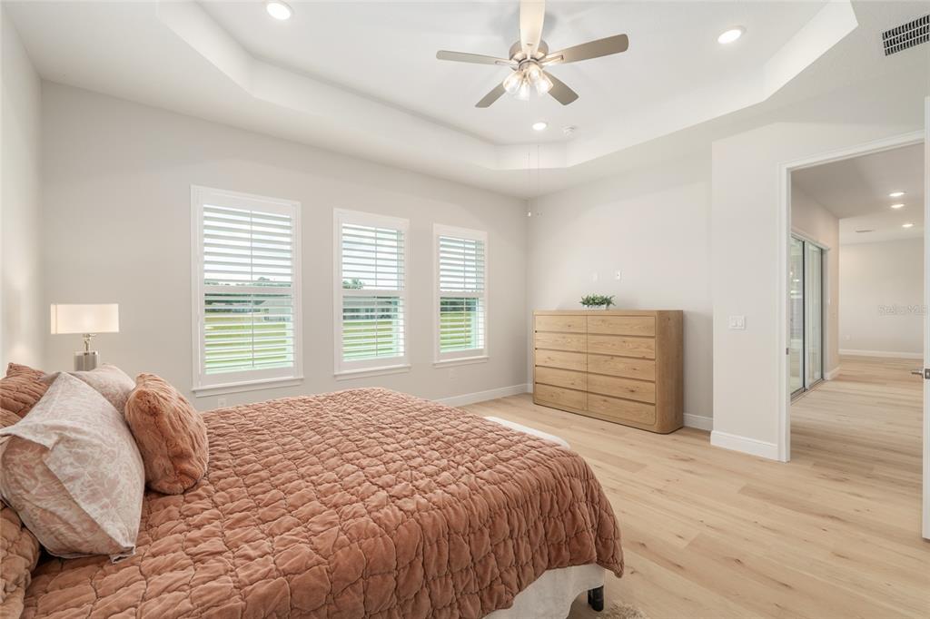 1929 Northwest 85th Loop Ocala, FL 34475 - Photo 29 of 55 a bedroom with a bed and a chandelier