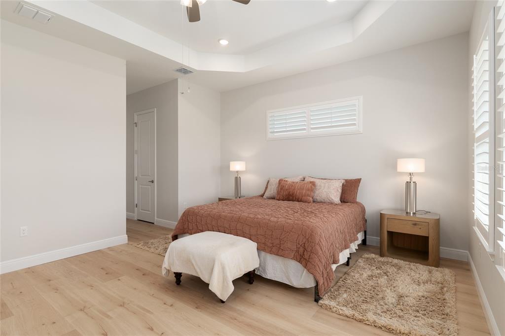 1929 Northwest 85th Loop Ocala, FL 34475 - Photo 31 of 55 a bedroom with a bed and a lamp