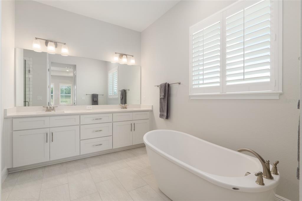 1929 Northwest 85th Loop Ocala, FL 34475 - Photo 33 of 55 a bathroom with a tub sink and mirror