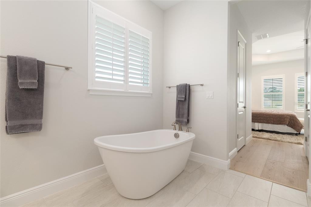 1929 Northwest 85th Loop Ocala, FL 34475 - Photo 35 of 55 a white bath tub sitting in a bathroom next to a window